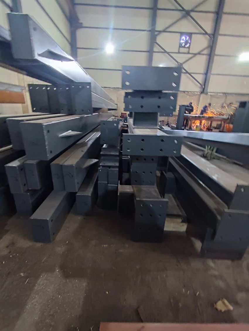 Stacked fabricated steel members with welding underway